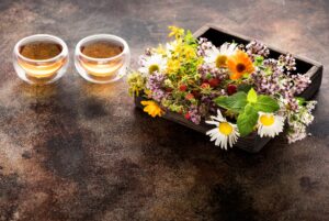 herbs and flowers for herbal healing tea in a wooden box and cups tea