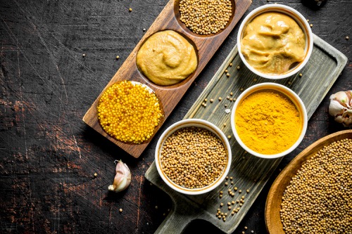 mustard in a plate on a cutting board and a stand 1 1