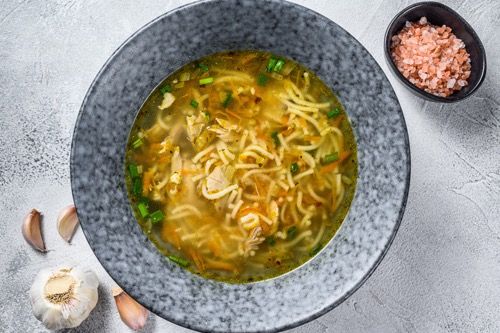 chicken bouillon soup with leek carrots noodles spring onions and parsley 1